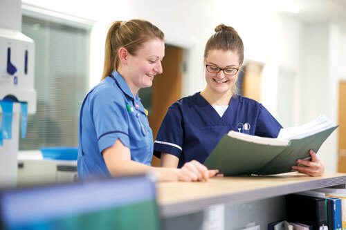 Nursing staff discussing a patient’s care in the centre.