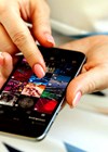Photo of person using Istagram reel on phone.